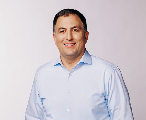 Headshot of Joe Del Preto, Chief Financial Officer, wearing a light blue collared shirt.