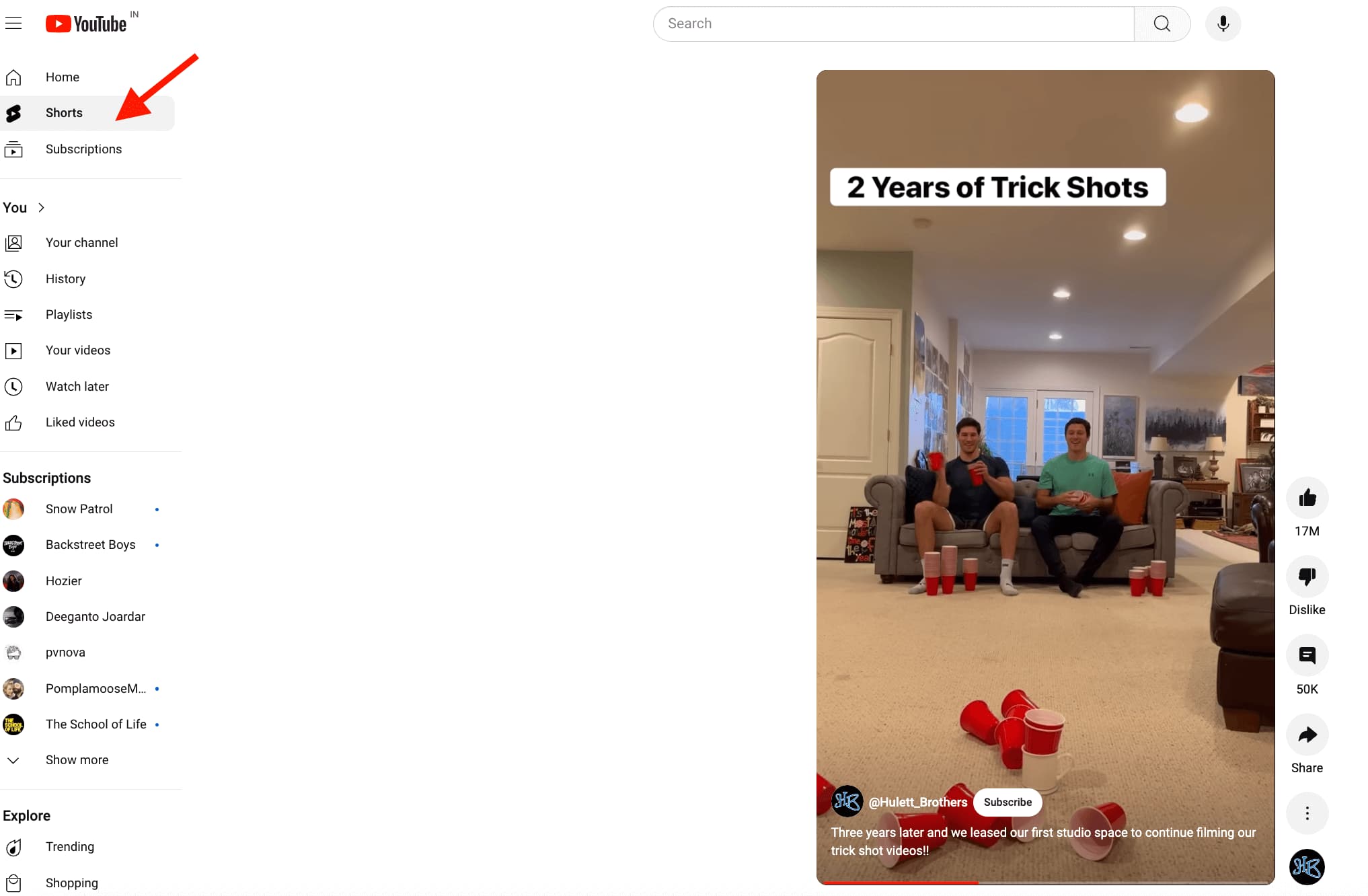 YouTube Shorts feed with arrow pointing to the Shorts